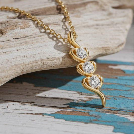 Gold necklace with a heart-shaped pendant on a wooden surface