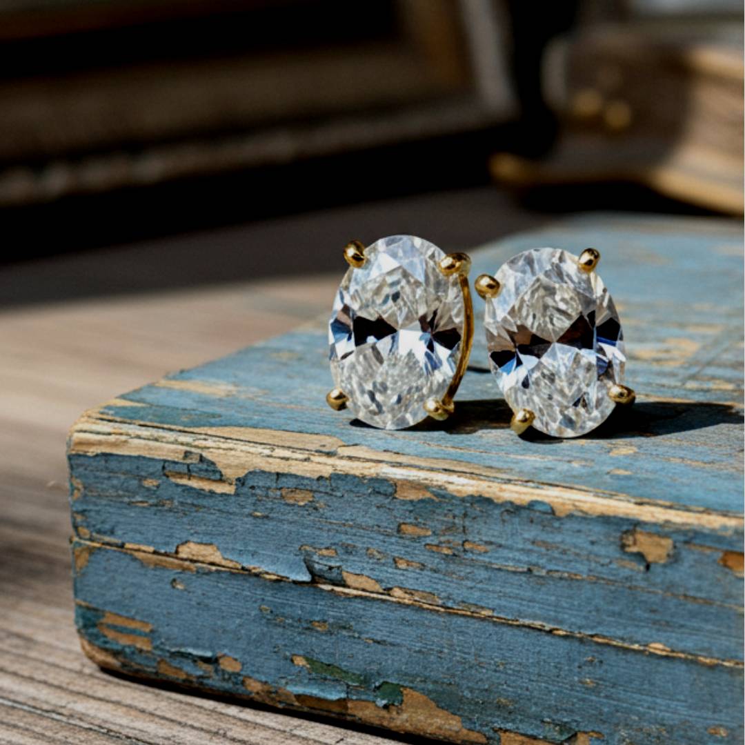 Pair of diamond earrings on a rustic wooden surface
