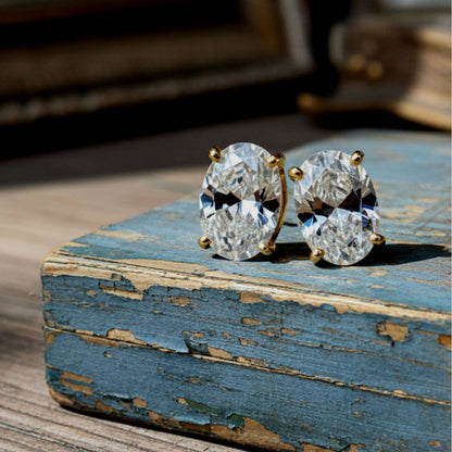 Pair of diamond earrings on a rustic wooden surface
