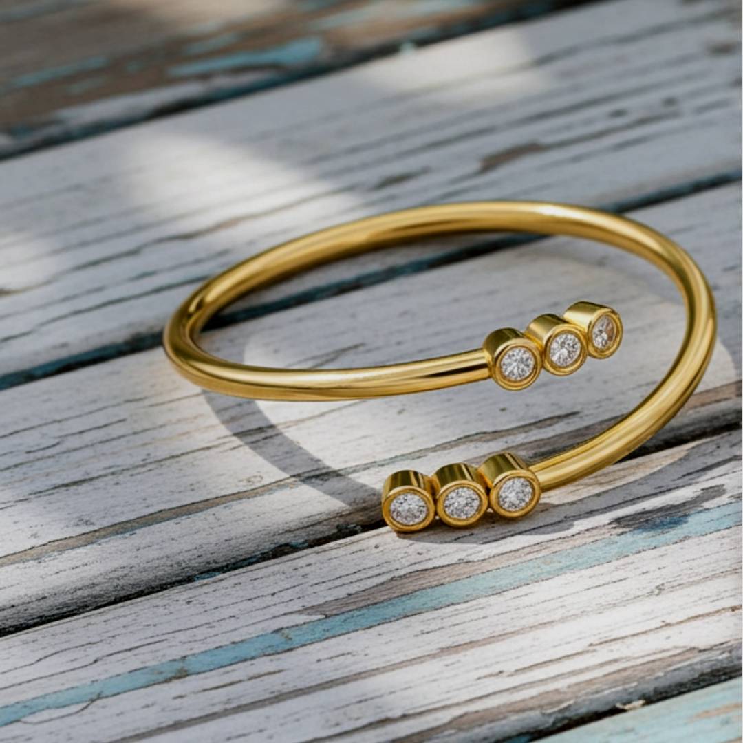 Gold bracelet with diamond accents on a wooden surface