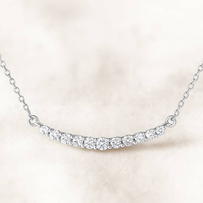 necklace with small diamonds on a light pink background