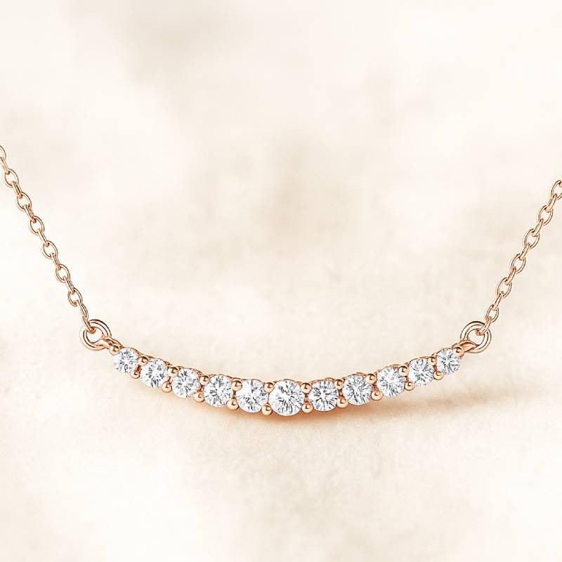 Rose gold necklace with diamonds on a soft beige background