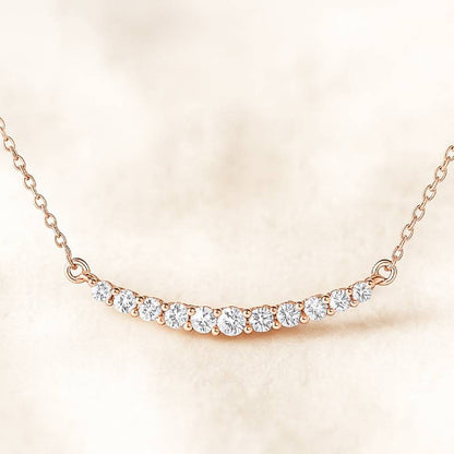 Rose gold necklace with diamonds on a soft beige background