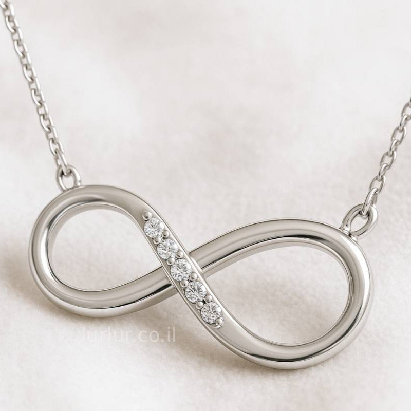  infinity necklace with small diamonds on a light background