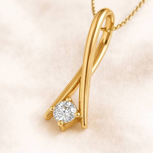 Gold necklace with a diamond pendant on a soft beige background