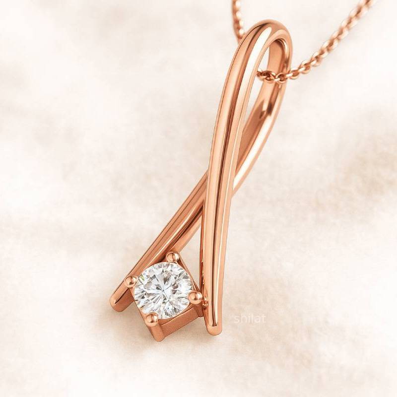Rose gold necklace with a diamond pendant on a soft beige background
