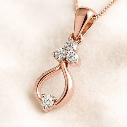 Rose gold pendant with diamonds on a light beige background