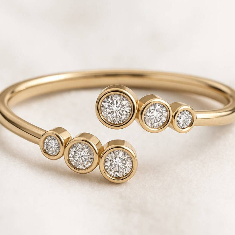 Gold ring with diamond beads on a light background