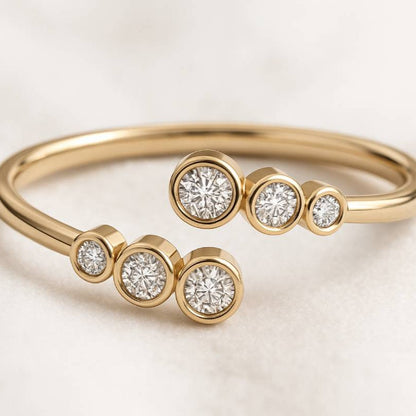 Gold ring with diamond beads on a light background