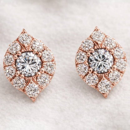 Rose gold and diamond earrings on a light background