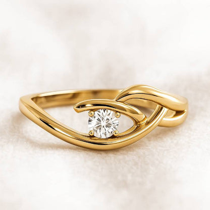 Gold ring with a diamond on a soft beige background
