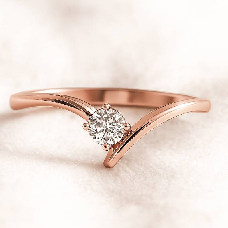 Rose gold ring with a diamond on a soft pink background