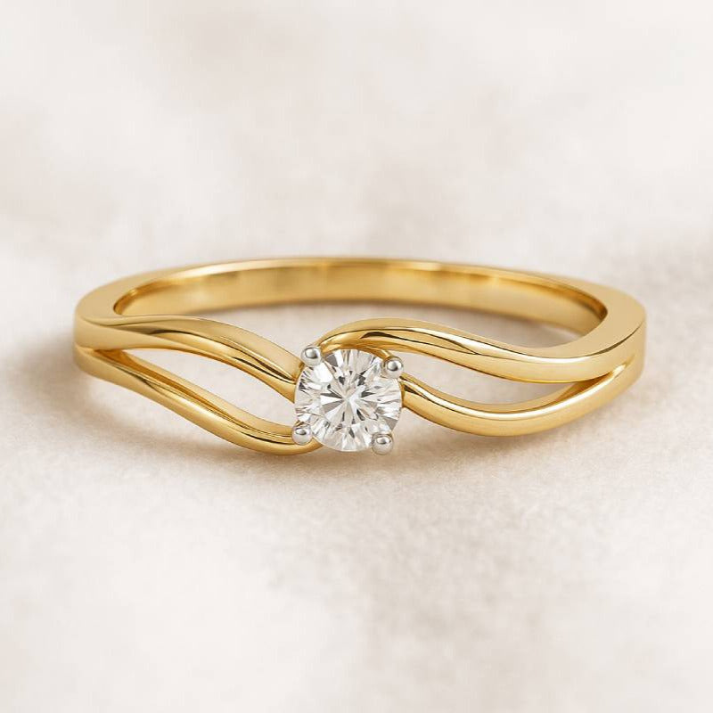 Gold ring with a diamond on a beige background