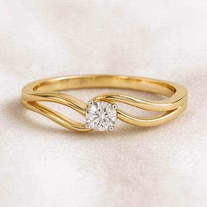 Gold ring with a diamond on a beige background