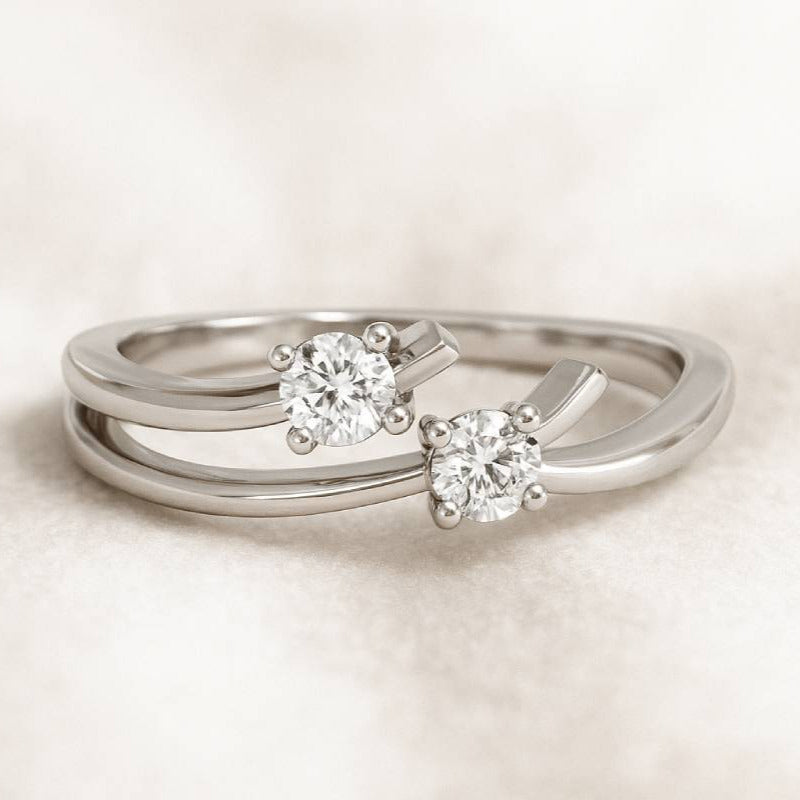 silver rings with diamond-like stones on a light background