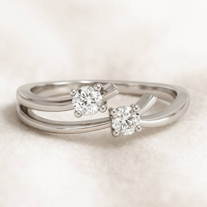 silver rings with diamond-like stones on a light background
