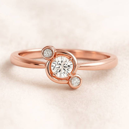 Rose gold ring with a central diamond and smaller diamonds on a light beige background