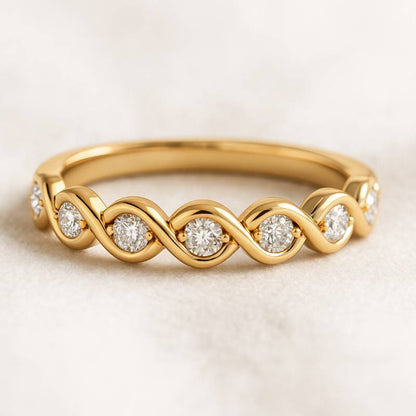 Gold ring with diamond stones on a light background