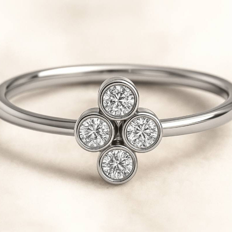 ring with four diamond stones on a beige background