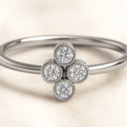 ring with four diamond stones on a beige background