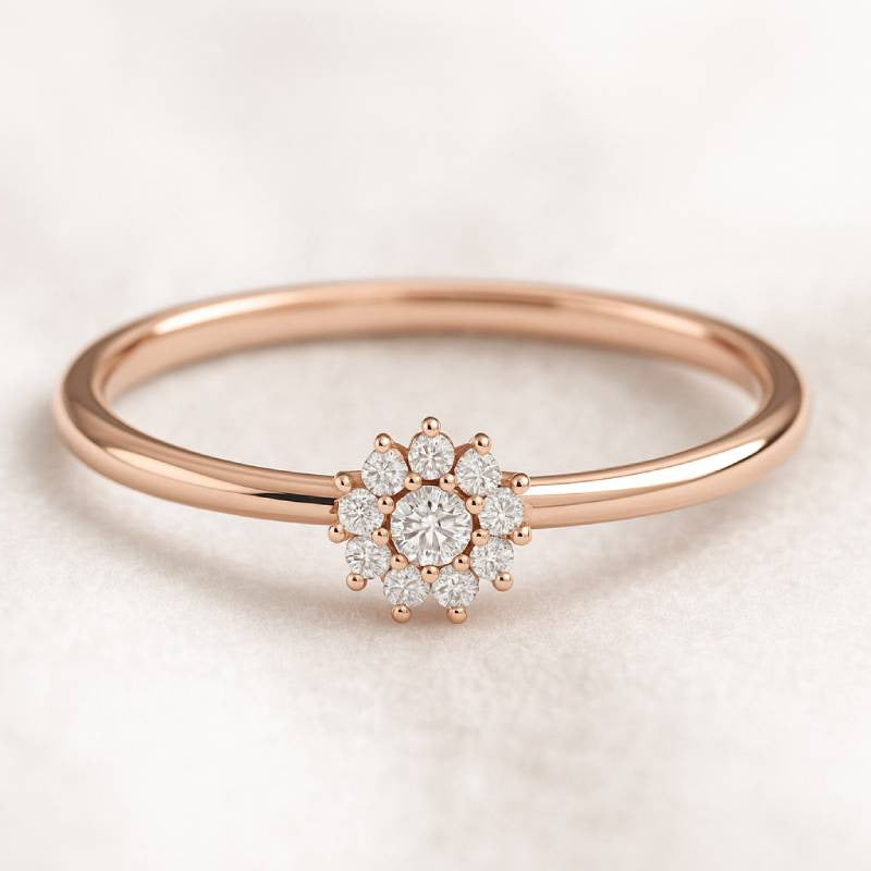 Rose gold ring with a diamond cluster on a light background