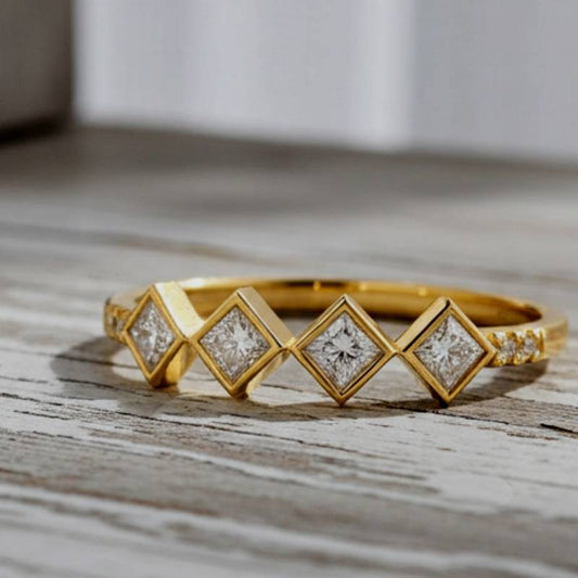 Gold ring with diamond accents on a wooden surface