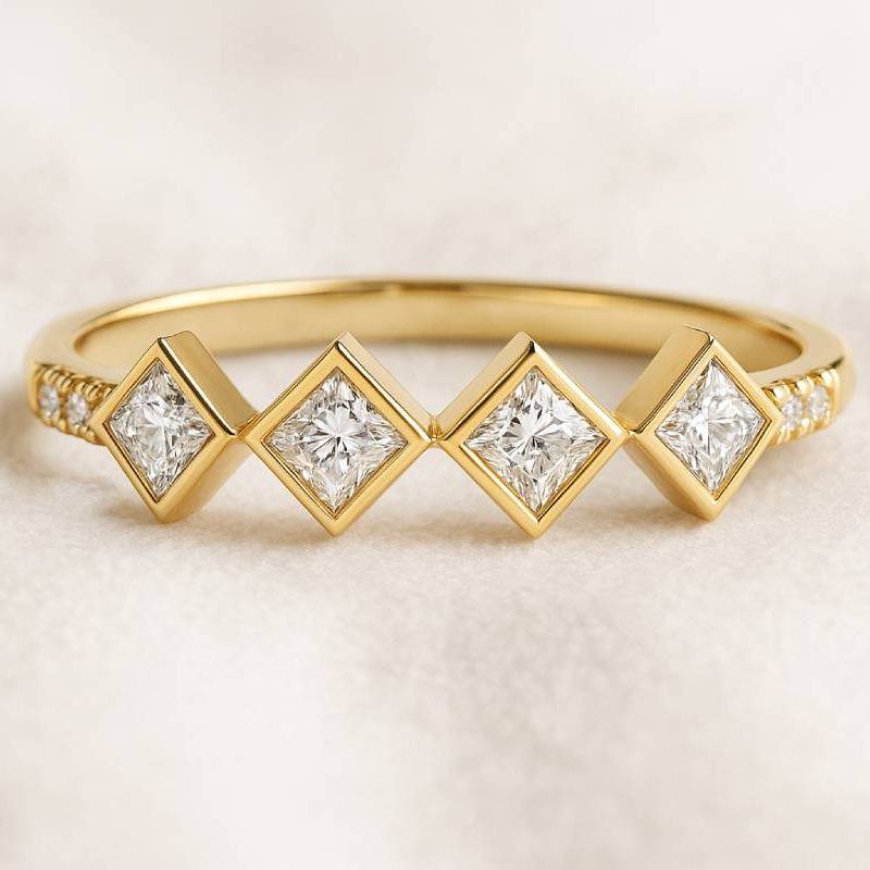 Gold ring with diamond-shaped gemstones on a beige background