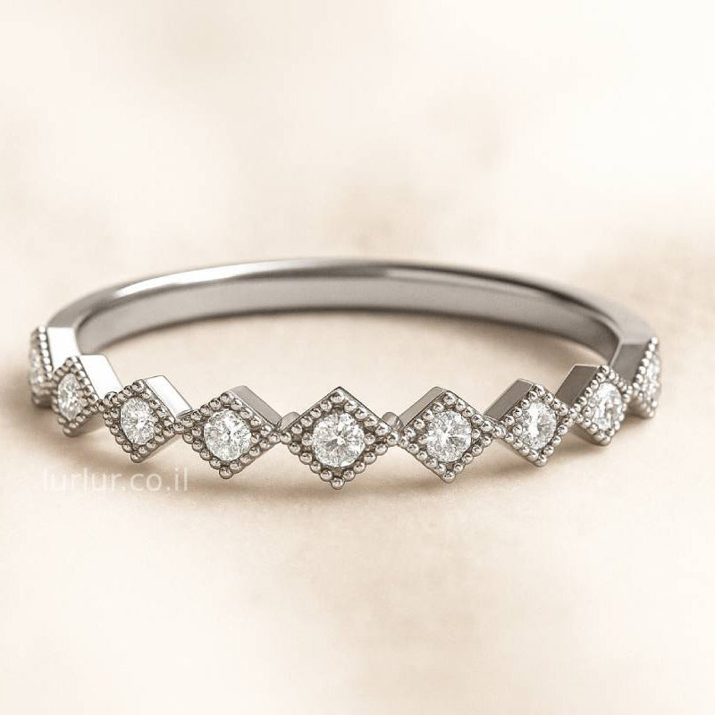 ring with diamond-shaped stones on a beige background