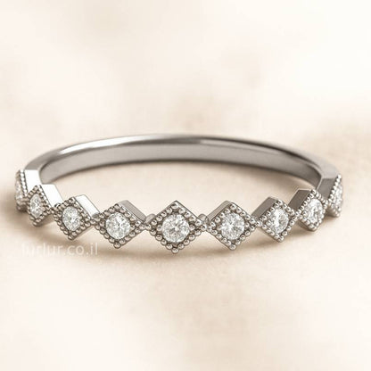 ring with diamond-shaped stones on a beige background