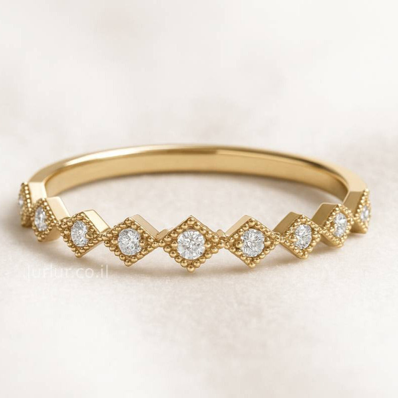 Gold ring with diamond accents on a light background