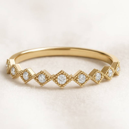 Gold ring with diamond accents on a light background