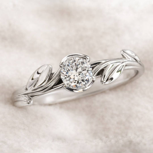 ring with leaf design and diamond on a soft beige background