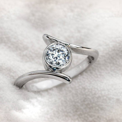 ring with a diamond on a light gray background