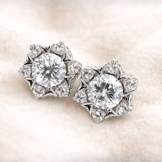 Pair of diamond earrings on a soft beige background