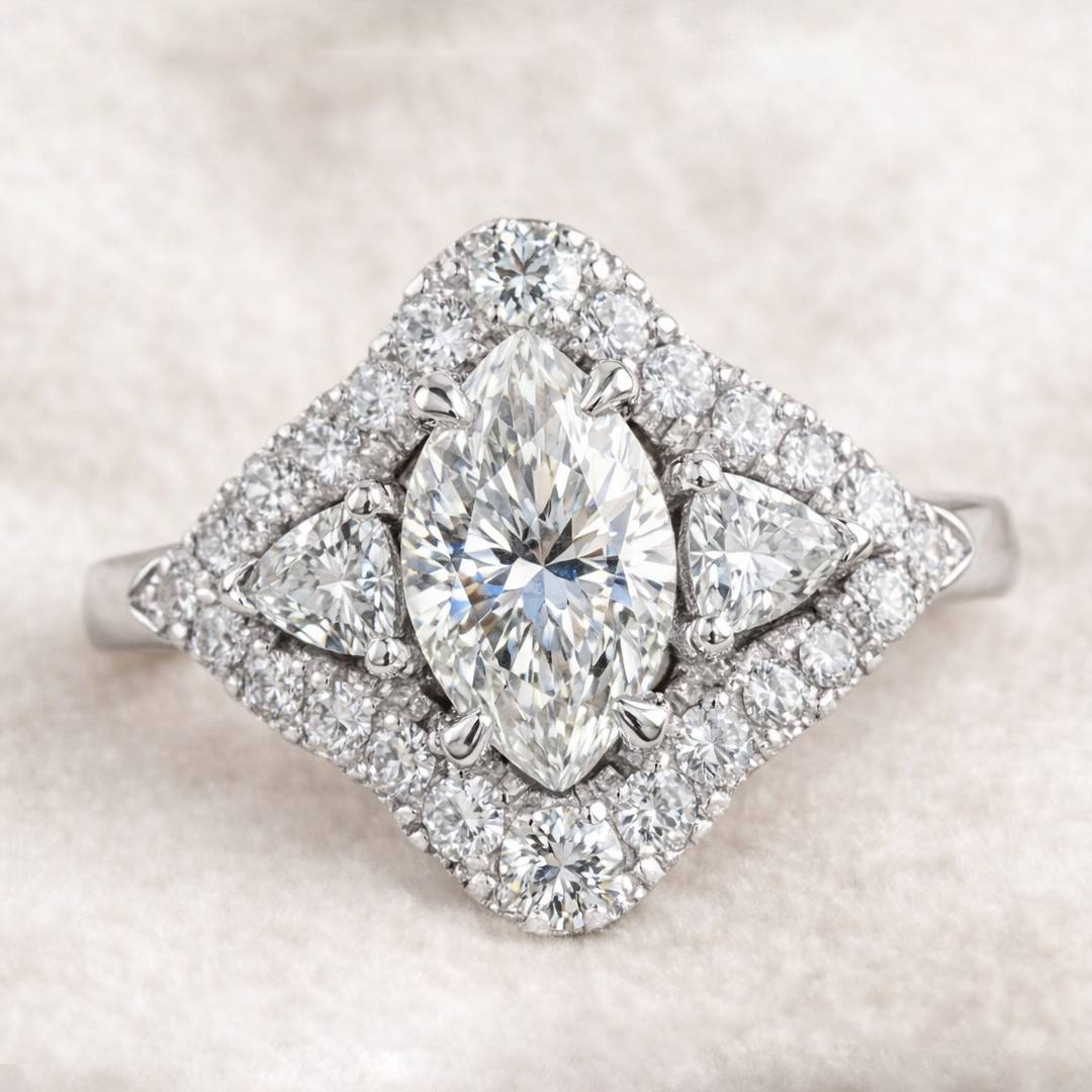 Diamond ring with pear-shaped center stone on a soft beige background