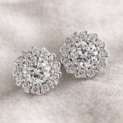 Pair of diamond earrings on a soft gray background
