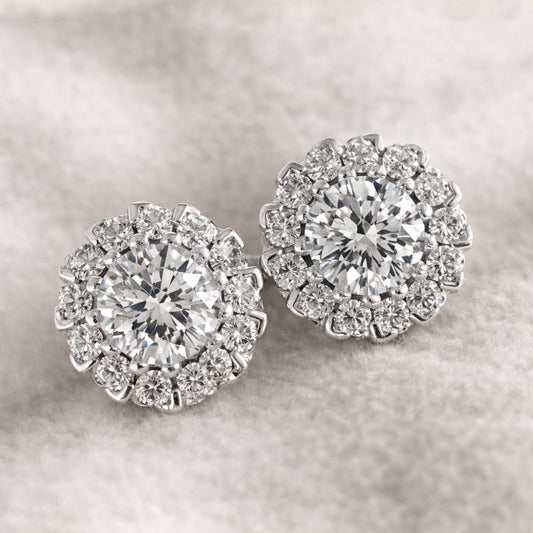 Pair of diamond earrings on a soft gray background