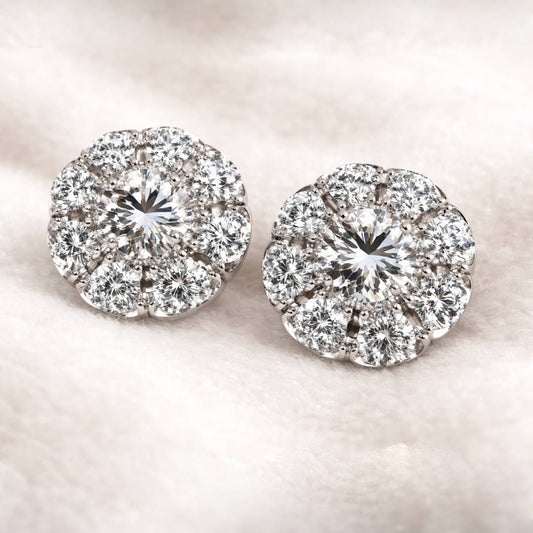 Pair of diamond earrings on a light pink background