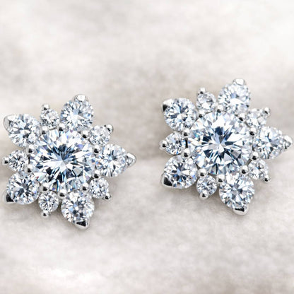 Pair of diamond earrings on a light background