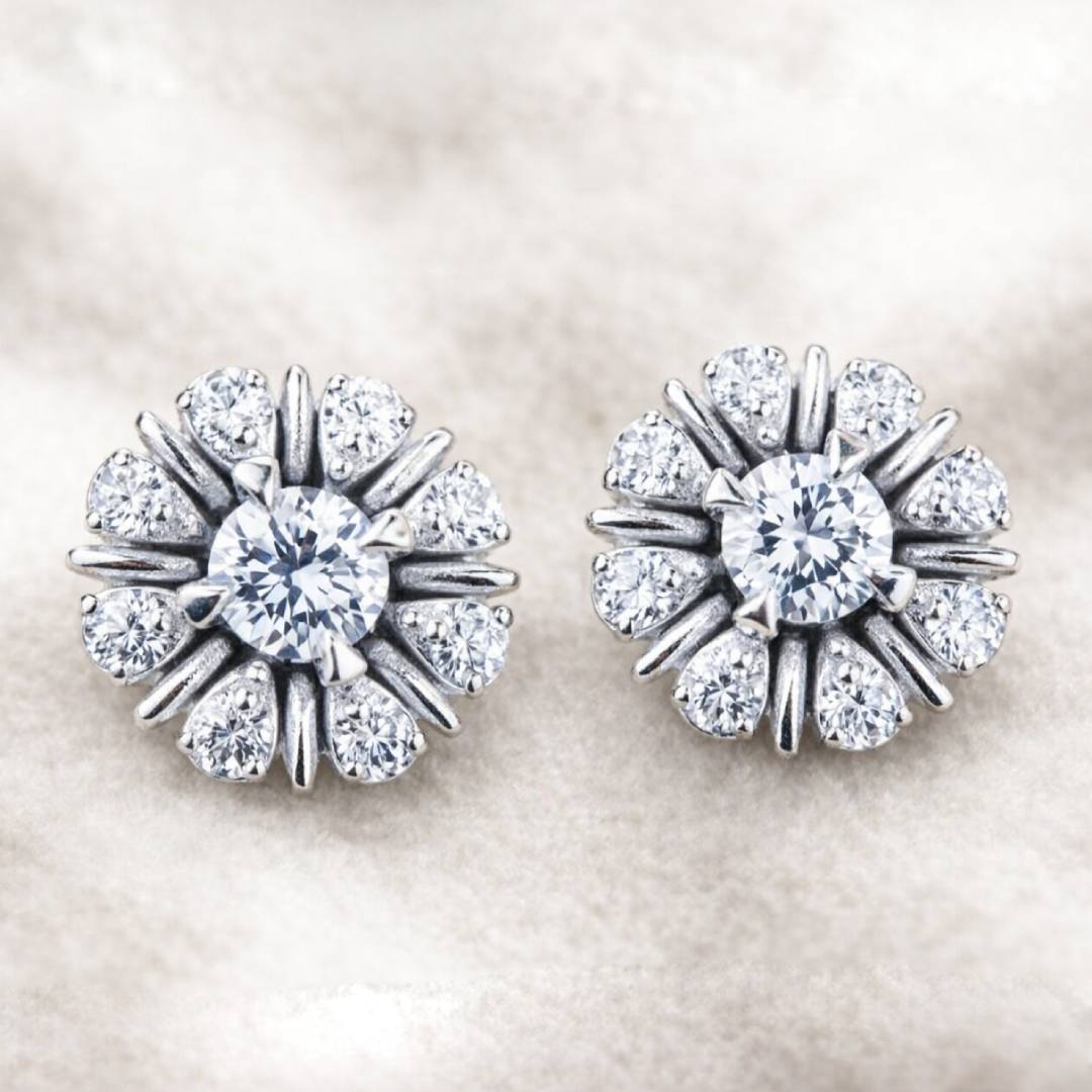 Pair of earrings with clear gemstones on a light background