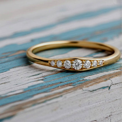 Gold ring with diamonds on a rustic wooden surface