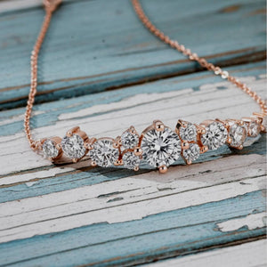 Rose gold and diamond bracelet on a wooden surface