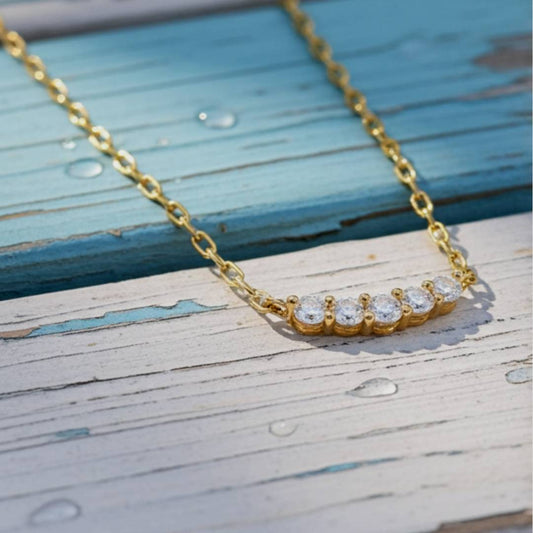 Gold necklace with diamonds on a wooden surface