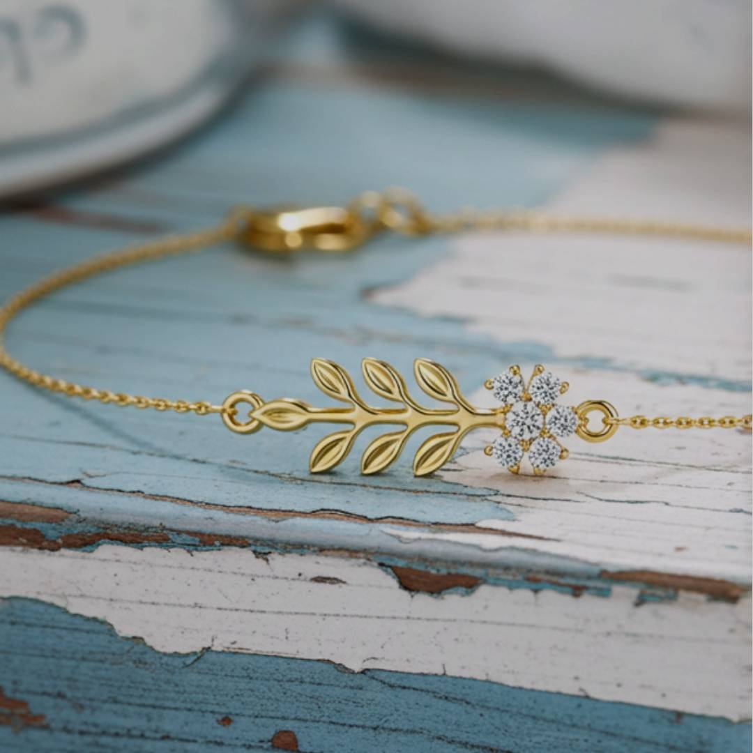 Gold bracelet with floral design on a rustic wooden surface