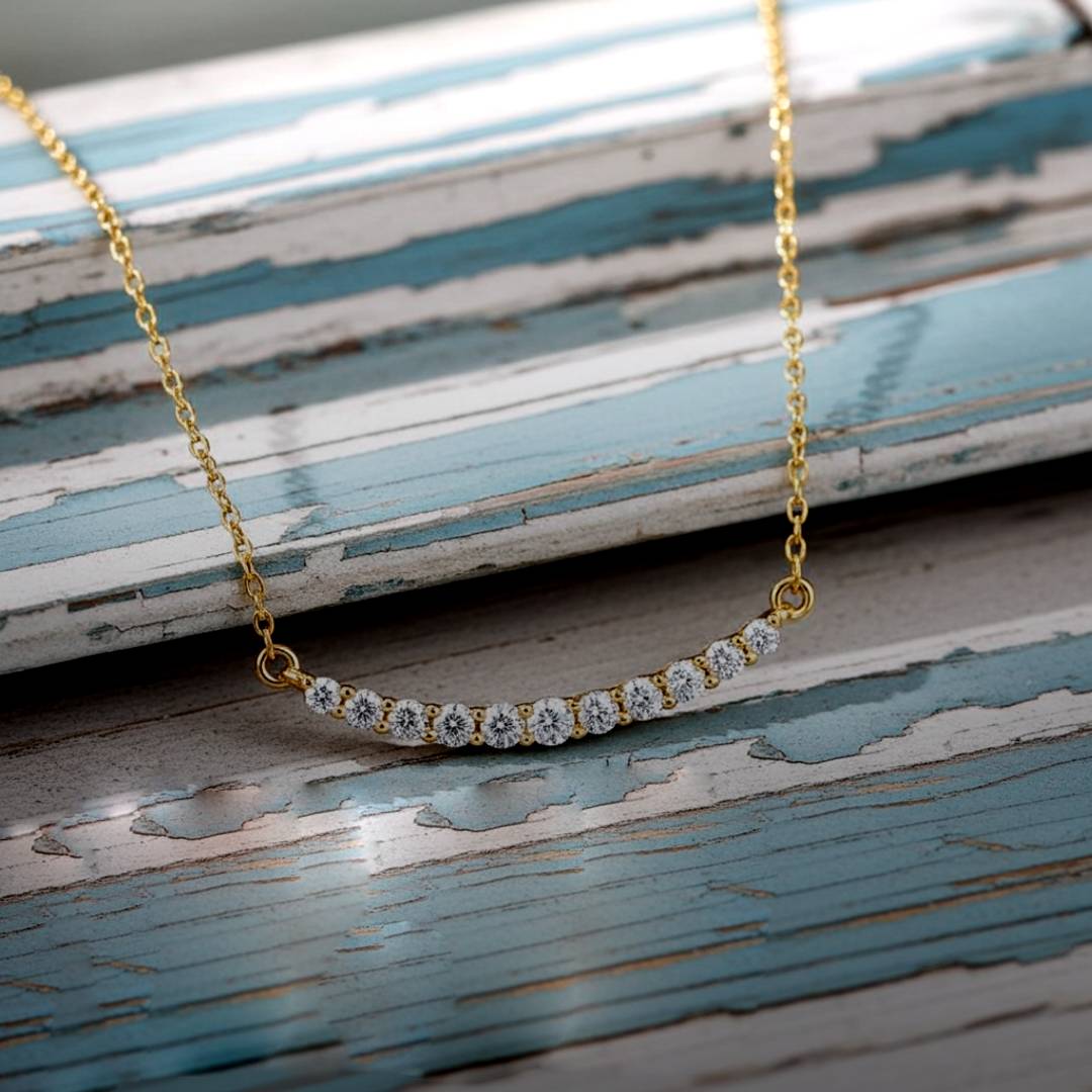 Gold necklace with diamonds on a textured wooden surface