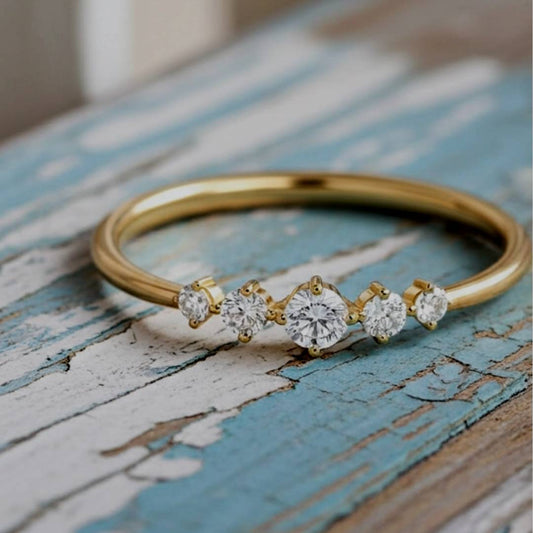 Gold ring with diamonds on a rustic wooden surface