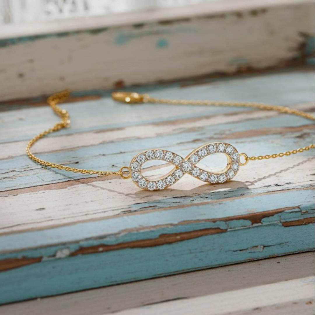Gold bracelet with an infinity design on a rustic wooden surface