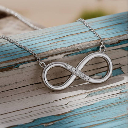  infinity necklace on a rustic wooden surface