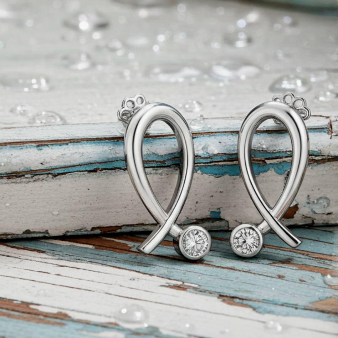  heart-shaped earrings with gemstones on a rustic wooden surface.