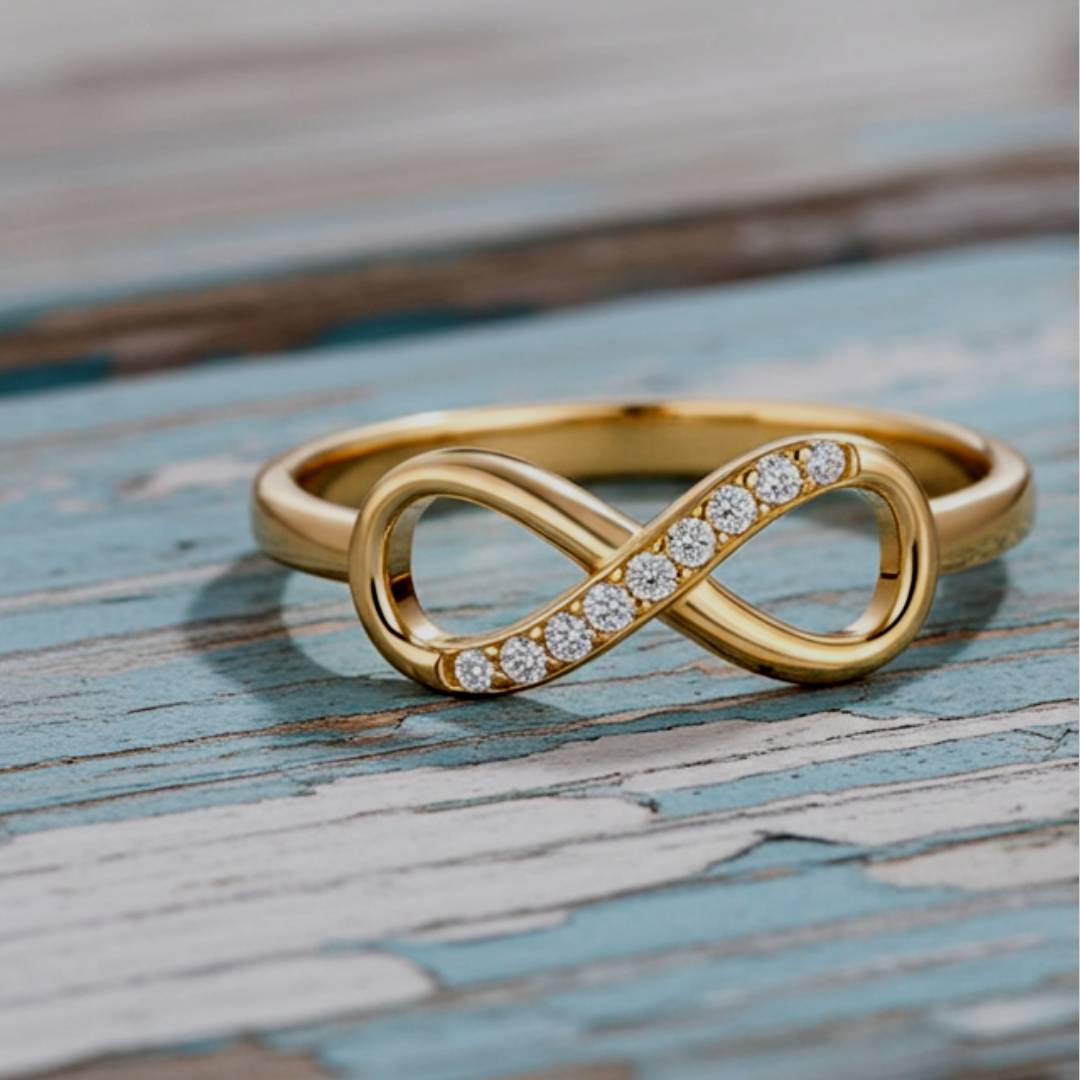 Gold infinity ring with diamonds on a wooden surface